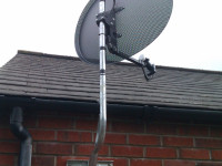 Satellite dish on the side wall of a house Satellite Dish Repairs and TV Aerial Services in Larne Carrickfergus Newtownabbey